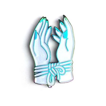 Bound_Hands_by_Hannah_Nance_Rainbow_Anodized_Pin_450x450